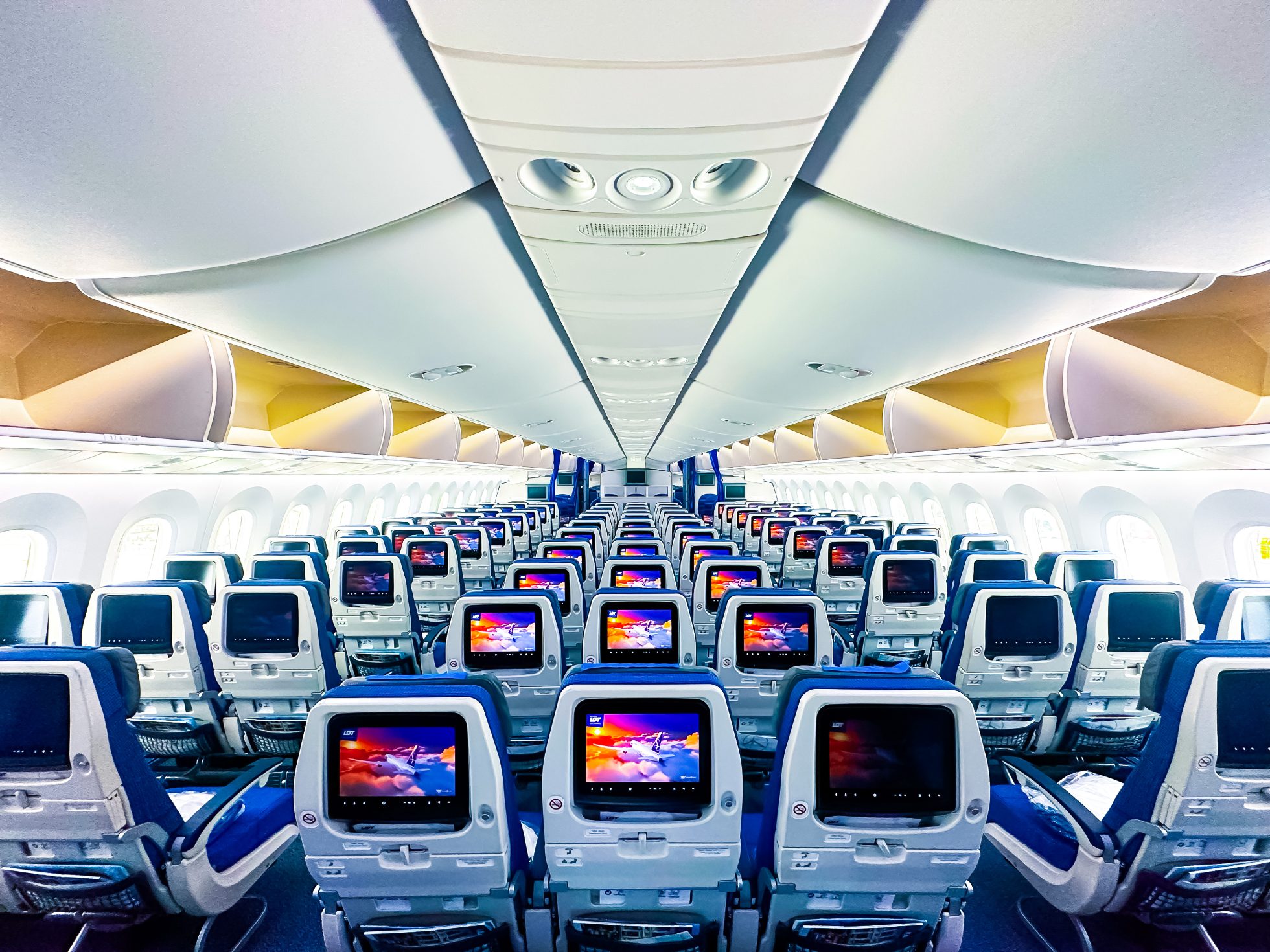 Interior view of a Boeing 787-9 Dreamliner economy class cabin.